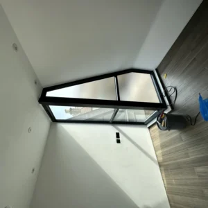 Angled black aluminium apex window in London loft room