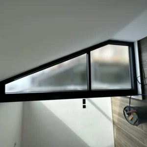 Triangular black aluminium gable window in London loft conversion