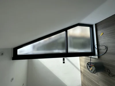 Triangular black aluminium gable window in London loft conversion