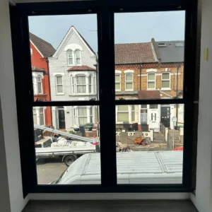 Navy aluminium double casement window overlooking London street