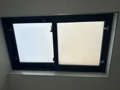 Black aluminium frosted tilt-turn window in London bathroom