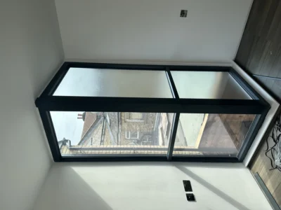 Black aluminium frosted casement window in London loft bathroom