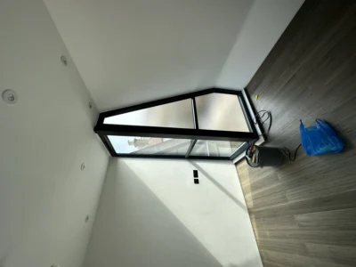 Angled black aluminium gable window with rooflight, London loft