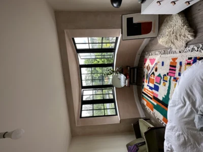Black aluminium Crittall-style window in London bedroom