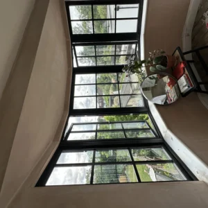 Large black aluminium Crittall-style corner window, London room