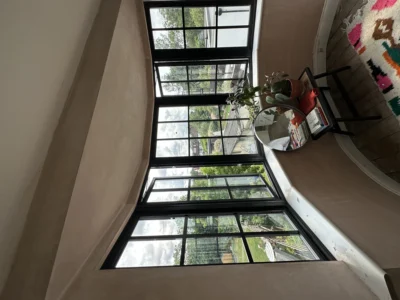 Large black aluminium Crittall-style corner window, London room