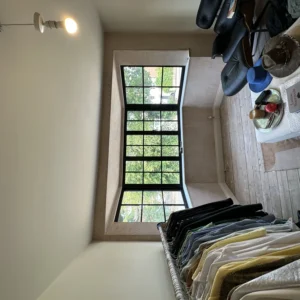 Slim black aluminium Crittall-style window in London room
