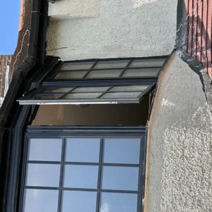 Dark aluminium bay window with top lights, London house front