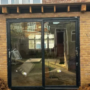 Anthracite aluminium bifold doors on London brick extension
