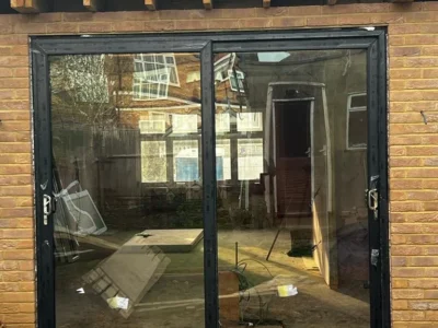 Anthracite aluminium bifold doors on London brick extension