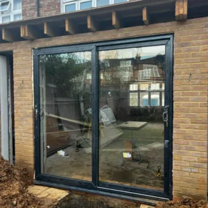 Grey aluminium bifold doors installed on London extension