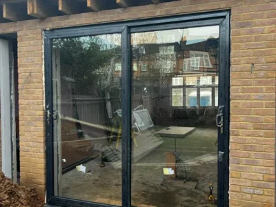Grey aluminium bifold doors installed on London extension