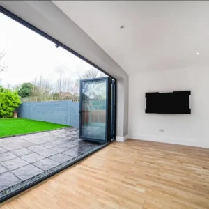 Open aluminium bifold doors to garden, London extension
