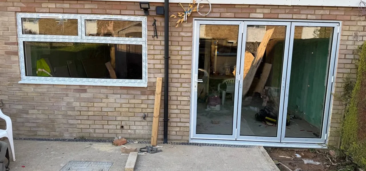 White uPVC bifold doors installation, London rear extension