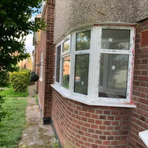 White uPVC bay casement windows on London brick property
