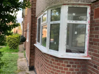 White uPVC bay casement windows on London brick property