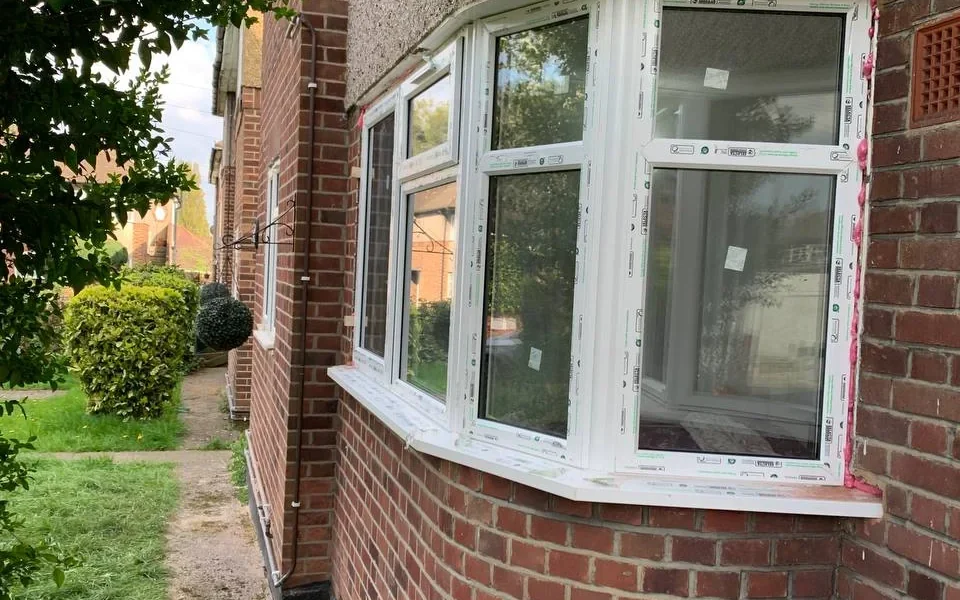 White uPVC bay casement windows on London brick property