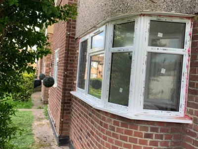White uPVC bay casement windows on London brick house