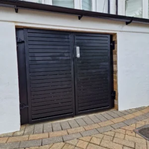 Black louvred metal garage doors London property