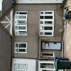 London house front with white uPVC bay and casement windows