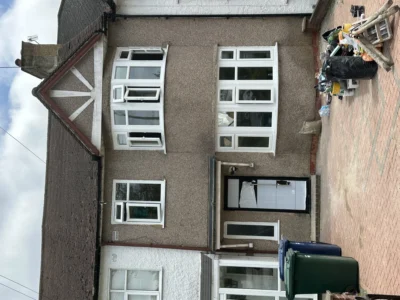 London house front with white uPVC bay and casement windows