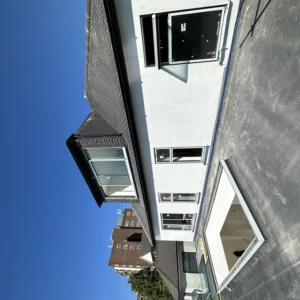 Rendered London house rear with aluminium windows, blue sky