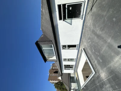 Rendered London house rear with aluminium windows, blue sky
