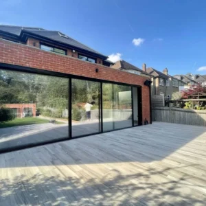 London rear extension with black sliding doors and balustrade