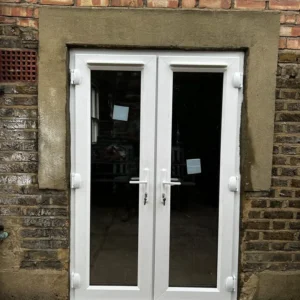 White uPVC French doors fitted to London brick rear wall