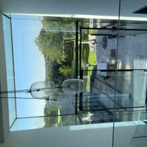 Frameless glass balustrade overlooking garden in London home