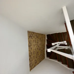 White staircase with glass balustrade in London townhouse