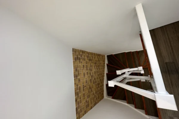 White staircase with glass balustrade in London townhouse