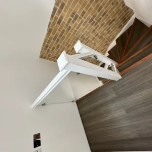 Glass staircase balustrade with brick feature wall, London