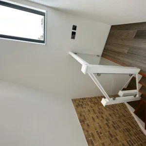Glass balustrade landing with black aluminium window, London loft