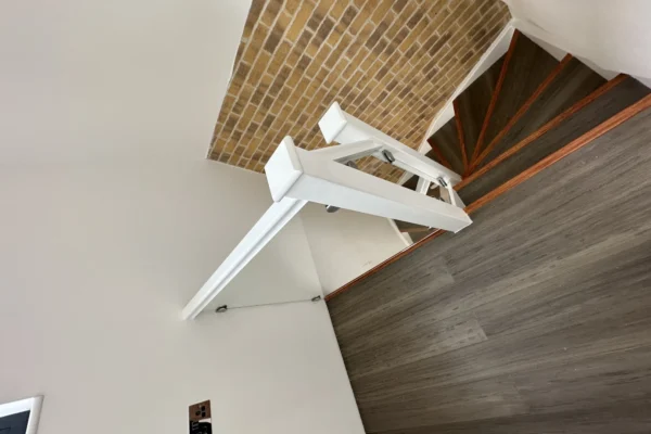 White staircase with frameless glass balustrade, London loft