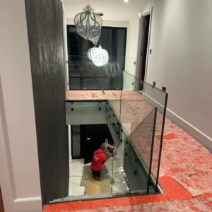Glass balustrade to London stairwell void during install