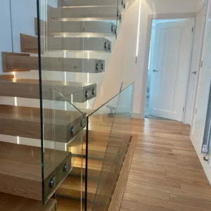 Glass balustrade on floating oak stairs, London property