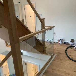 Glass balustrade with oak handrail on London staircase