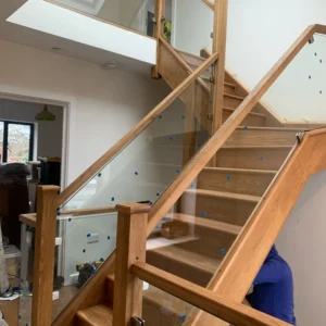 Glass balustrade and oak handrail on London staircase