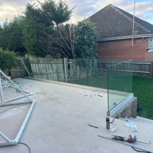 Frameless glass balustrade on London patio at dusk