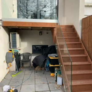 Glass balustrade on London raised timber deck staircase