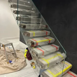 Frameless glass balustrade on marble staircase, London
