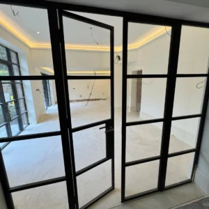 Crittall-style glass partition with pivot door, London room divider