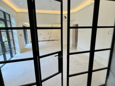 Crittall-style glass partition with pivot door, London room divider