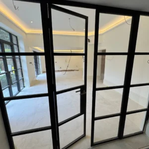 Black Crittall glass partition and pivot door, London