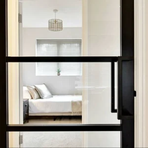Black Crittall glass partition door to bedroom, London