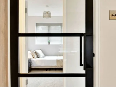 Black Crittall glass partition door to bedroom, London