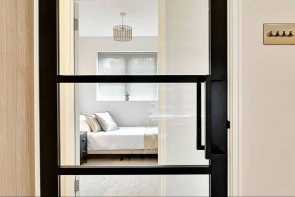 Black Crittall glass partition door to bedroom, London