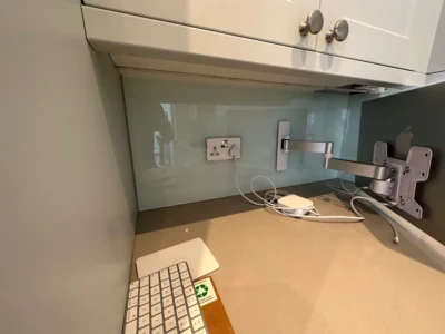 Frosted glass splashback above desk in London kitchen