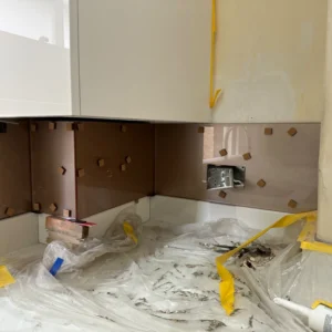 Bronze mirror glass splashback corner install, London kitchen